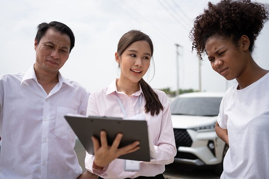 Two Asian Driver Talk To Insurance Agent For Examining Damaged