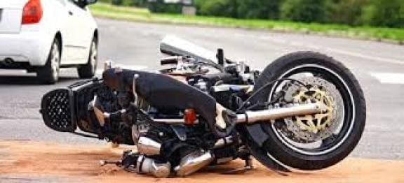 motorcycle accident scene after a collision between a car and a motorcyclist