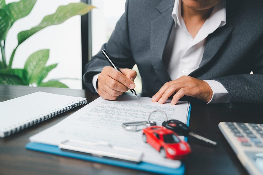 Car Dealer Business Woman Signing Car Insurance Document Or Leas