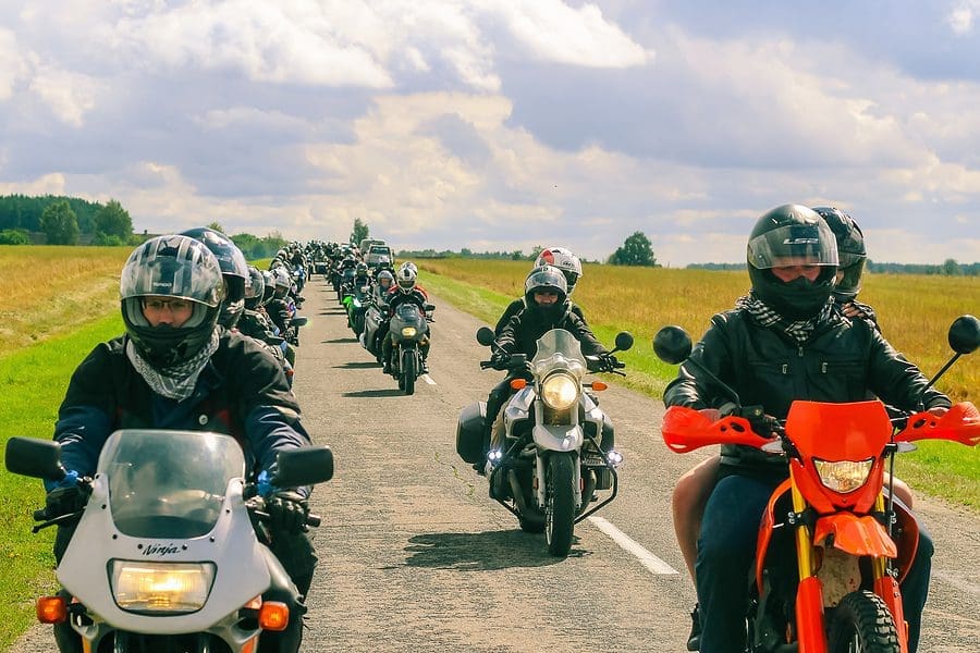 Group Of Motorcyclists Rides On Asphalt Country Road